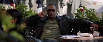 Movie still from “Captain America: The Winter Soldier” (2014), directed by Anthony Russo – A man sitting on a bench talking on a cell phone; Medium shot, High angle