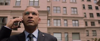 Movie still from “Captain America: The Winter Soldier” (2014), directed by Anthony Russo – A man in a suit and tie standing in front of a building; Close Up shot, Low angle