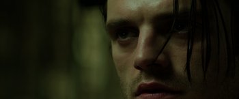 Movie still from “Captain America: The Winter Soldier” (2014), directed by Anthony Russo – A man's face in a dimly - lit room; Extreme Close Up shot, Low angle