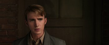 Movie still from “Captain America: The Winter Soldier” (2014), directed by Anthony Russo – A man in a suit and tie looking at the camera; Close Up shot, Low angle