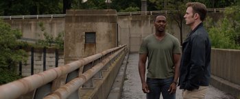 Movie still from “Captain America: The Winter Soldier” (2014), directed by Anthony Russo – A man standing next to a railing on a bridge; Medium shot, Low angle