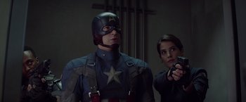 Movie still from “Captain America: The Winter Soldier” (2014), directed by Anthony Russo – A man and a woman are standing next to each other; Medium shot, Low angle