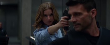 Movie still from “Captain America: The Winter Soldier” (2014), directed by Anthony Russo – A woman holding a gun in front of a man; Close Up shot, Over the shoulder angle
