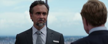 Movie still from “Captain America: The Winter Soldier” (2014), directed by Anthony Russo – A person wearing a suit and tie; Close Up shot, Over the shoulder angle