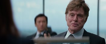 Movie still from “Captain America: The Winter Soldier” (2014), directed by Anthony Russo – A man in a suit and tie holding a cell phone; Close Up shot, Over the shoulder angle