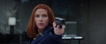 Movie still from “Captain America: The Winter Soldier” (2014), directed by Anthony Russo – A woman with red hair holding up a gun; Close Up shot, Low angle