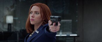 Movie still from “Captain America: The Winter Soldier” (2014), directed by Anthony Russo – A woman with red hair is holding a gun; Close Up shot, Over the shoulder angle