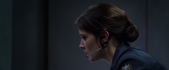 Movie still from “Captain America: The Winter Soldier” (2014), directed by Anthony Russo – A woman wearing a headset is looking into the distance; Close Up shot, Low angle