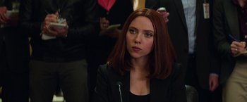 Movie still from “Captain America: The Winter Soldier” (2014), directed by Anthony Russo – A person wearing a suit and tie; Close Up shot, Over the shoulder angle