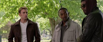 Movie still from “Captain America: The Winter Soldier” (2014), directed by Anthony Russo – Two men standing next to each other near a tree; Medium shot, Over the shoulder angle