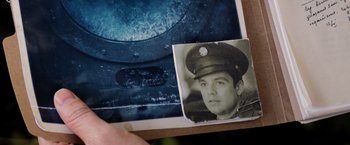 Movie still from “Captain America: The Winter Soldier” (2014), directed by Anthony Russo – An old photo of a man wearing a hat; Extreme Close Up shot, Overhead angle