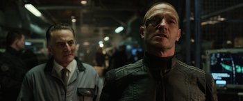 Movie still from “Captain America: The Winter Soldier” (2014), directed by Anthony Russo – A man and a woman standing next to each other in a room; Close Up shot, Over the shoulder angle