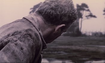 Movie still from “The Sacrifice” (1986), directed by Andrei Tarkovsky – A man with a wet shirt on looking down; Close Up shot, Low angle