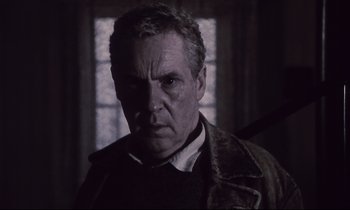 Movie still from “The Sacrifice” (1986), directed by Andrei Tarkovsky – A person wearing a jacket; Close Up shot, Low angle