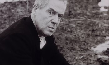 Movie still from “The Sacrifice” (1986), directed by Andrei Tarkovsky – An older man in a black suit and white shirt; Close Up shot, Low angle