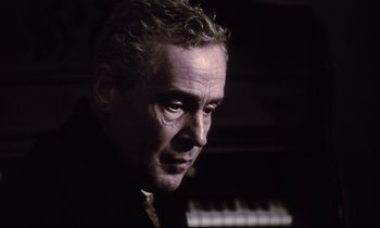 Movie still from “The Sacrifice” (1986), directed by Andrei Tarkovsky – A person with a keyboard; Close Up shot, Low angle