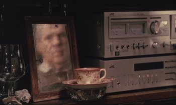 Movie still from “The Sacrifice” (1986), directed by Andrei Tarkovsky – A coffee cup sitting on a plate next to a mirror; Close Up shot, Over the shoulder angle