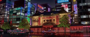 Movie still from “Cars 2” (2011), directed by John Lasseter – An asian building with a car parked in front of it; Extreme Wide shot, Low angle