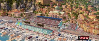 Movie still from “Cars 2” (2011), directed by John Lasseter – An aerial view of an outdoor stadium with a lot of cars parked around it; Extreme Wide shot, High angle