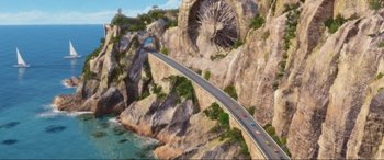 Movie still from “Cars 2” (2011), directed by John Lasseter – An aerial view of a road going over a bridge; Extreme Wide shot, High angle