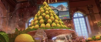 Movie still from “Cars 2” (2011), directed by John Lasseter – A large pile of lemons sitting on top of a table; Extreme Close Up shot, Low angle