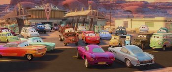 Movie still from “Cars 2” (2011), directed by John Lasseter – A bunch of cars that are in the street; Wide shot, High angle