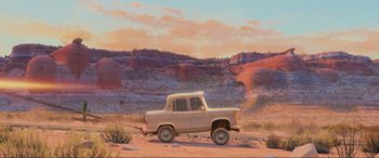 Movie still from “Cars 2” (2011), directed by John Lasseter – An illustration of an old truck in the middle of the desert; Extreme Wide shot, Low angle