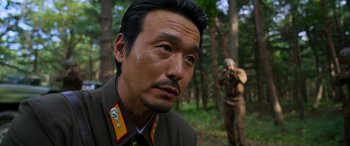 Movie still from “Carter” (2022), directed by Jung Byung-gil – A person wearing a military uniform; Close Up shot, Over the shoulder angle