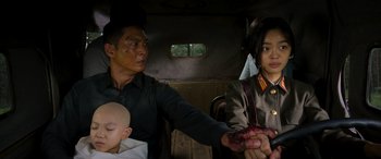 A man and a woman in the back of a vehicle