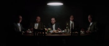Movie still from “Casino” (1995), directed by Martin Scorsese – A group of men sitting at a dinner table; Wide shot, Low angle