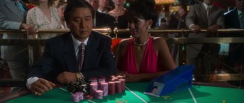 A man and a woman sitting at a poker table