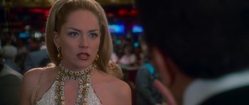 Movie still from “Casino” (1995), directed by Martin Scorsese – A woman in a white dress is talking to a man; Close Up shot, Over the shoulder angle