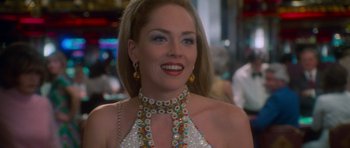 Movie still from “Casino” (1995), directed by Martin Scorsese – A woman wearing a necklace and earrings in a restaurant; Close Up shot, Over the shoulder angle