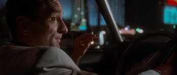 Movie still from “Casino” (1995), directed by Martin Scorsese – A man sitting in the driver's seat of a car holding a cigarette; Close Up shot, Low angle