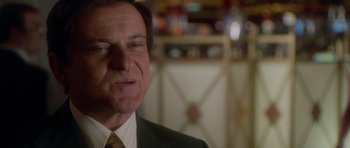 Movie still from “Casino” (1995), directed by Martin Scorsese – A person wearing a suit and tie; Close Up shot, Low angle