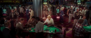 Movie still from “Casino” (1995), directed by Martin Scorsese – A group of people sitting at a table playing cards; Wide shot, High angle