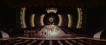 Movie still from “Casino” (1995), directed by Martin Scorsese – A group of people standing in front of a stage; Extreme Wide shot, High angle