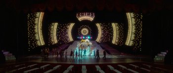 Movie still from “Casino” (1995), directed by Martin Scorsese – A group of people standing in front of a stage; Extreme Wide shot, High angle