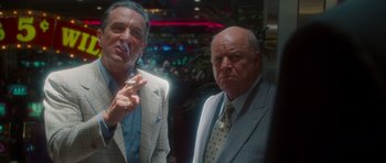 Movie still from “Casino” (1995), directed by Martin Scorsese – Two men standing next to each other in suits and ties; Medium shot, Low angle