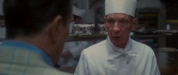Movie still from “Casino” (1995), directed by Martin Scorsese – A man wearing a chef's hat in front of a mirror; Close Up shot, Over the shoulder angle