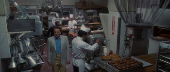 Movie still from “Casino” (1995), directed by Martin Scorsese – A group of people in a kitchen preparing food; Wide shot, High angle