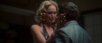 Movie still from “Casino” (1995), directed by Martin Scorsese – A woman in a black top and a man in a blue suit; Close Up shot, Over the shoulder angle