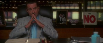Movie still from “Casino” (1995), directed by Martin Scorsese – A man sitting at a desk in front of a picture of a woman; Close Up shot, Over the shoulder angle