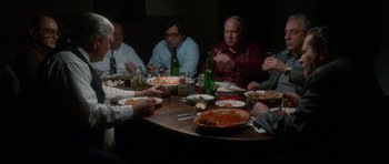 Movie still from “Casino” (1995), directed by Martin Scorsese – A group of people sitting around a table eating food; Medium shot, High angle