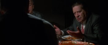 Movie still from “Casino” (1995), directed by Martin Scorsese – Two men sitting at a dinner table talking to each other; Close Up shot, Over the shoulder angle