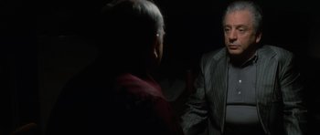 Movie still from “Casino” (1995), directed by Martin Scorsese – A man in a suit and tie talking to another man in a suit and tie; Medium shot, Over the shoulder angle