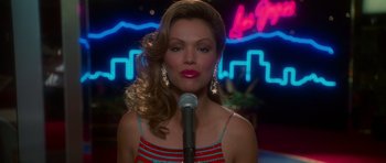 Movie still from “Casino” (1995), directed by Martin Scorsese – A woman in a red and blue dress holding a microphone; Close Up shot, Low angle