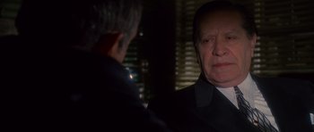 Movie still from “Casino” (1995), directed by Martin Scorsese – A man in a suit and tie looking at a man in a suit; Close Up shot, Over the shoulder angle