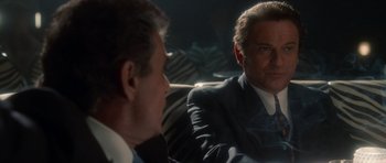 Movie still from “Casino” (1995), directed by Martin Scorsese – A man in a suit and tie sitting next to another man in a suit and tie; Close Up shot, Over the shoulder angle