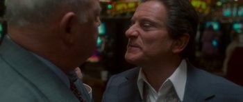 Movie still from “Casino” (1995), directed by Martin Scorsese – A man in a suit and tie talking to another man in a suit and tie; Close Up shot, Over the shoulder angle